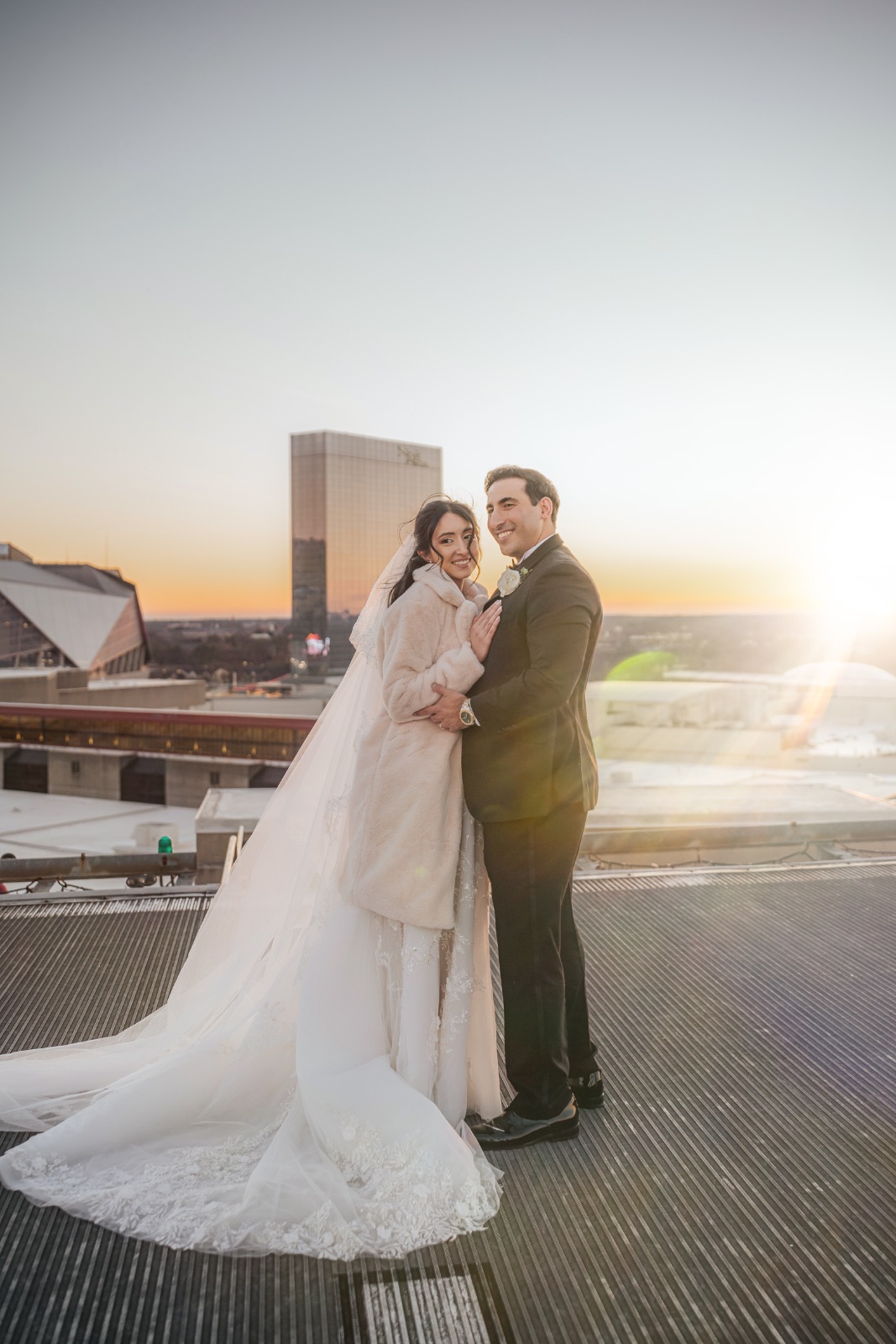 Couple at golden hour on a rooftop overlooking the city