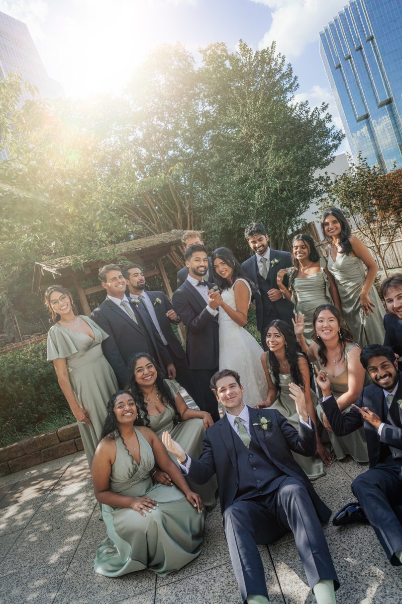 Wedding party laughing together outdoors